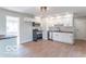 Updated kitchen with stainless steel appliances and wood-look flooring at 10138 Catalina Dr, Indianapolis, IN 46235