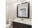 Bathroom with dark brown vanity and a large mirror at 11436 Mossy Ct # 102, Fishers, IN 46037