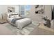 Cozy bedroom featuring a comfortable bed, stylish artwork, and natural light from the window at 11436 Mossy Ct # 102, Fishers, IN 46037