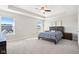 Spacious bedroom with carpeted floor, ceiling fan, and large windows at 11436 Mossy Ct # 102, Fishers, IN 46037