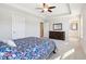 Main bedroom with carpeted floor, ceiling fan, and access to en suite bathroom at 11436 Mossy Ct # 102, Fishers, IN 46037