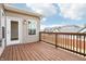 A gorgeous wooden deck with a white door, overlooking views of other houses and a blue sky at 11436 Mossy Ct # 102, Fishers, IN 46037