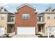 Charming townhome featuring a brick facade and attached one-car garage and modern siding at 11436 Mossy Ct # 102, Fishers, IN 46037