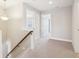 Upper level hallway with carpeted floor and doors to bedrooms and bath at 11436 Mossy Ct # 102, Fishers, IN 46037