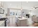 Open concept kitchen with island, stainless steel appliances, and light gray cabinetry at 11436 Mossy Ct # 102, Fishers, IN 46037