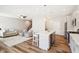 Open concept kitchen and living area with gray cabinets and island at 11436 Mossy Ct # 102, Fishers, IN 46037