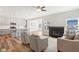 Open living space with fireplace, kitchen island, and hardwood floors at 11436 Mossy Ct # 102, Fishers, IN 46037