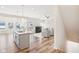 Open concept kitchen, living room, and dining area with hardwood floors at 11436 Mossy Ct # 102, Fishers, IN 46037