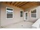 Relaxing outdoor patio featuring a white door, several windows, and views of the yard at 11436 Mossy Ct # 102, Fishers, IN 46037