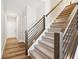 Modern staircase with wood and metal railing, leading to upper level at 11436 Mossy Ct # 102, Fishers, IN 46037