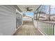 Inviting covered back porch features wood flooring, a ceiling fan, and a white railing offering outdoor relaxation at 1224 Keystone Ave, Indianapolis, IN 46201