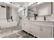 Bright bathroom with a soaking tub, glass shower, and double vanity sink at 1224 Keystone Ave, Indianapolis, IN 46201