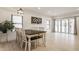 Dining room area with wood table, white chairs, modern light fixture and large windows at 1224 Keystone Ave, Indianapolis, IN 46201