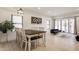 Dining room area with wood table, white chairs, modern light fixture and large windows at 1224 Keystone Ave, Indianapolis, IN 46201