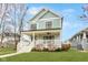 Charming two-story home featuring a welcoming front porch, well-manicured lawn, and beautiful architectural details at 1224 Keystone Ave, Indianapolis, IN 46201