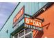 Exterior shot of 8th Day Distillery, highlighting its signage, location, and urban charm at 1224 Keystone Ave, Indianapolis, IN 46201