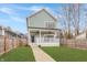 Charming two-story home with a inviting front porch and manicured front lawn at 1224 Keystone Ave, Indianapolis, IN 46201