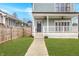 Charming home features a covered front porch, manicured lawn, and a walkway leading to the inviting entrance at 1224 Keystone Ave, Indianapolis, IN 46201