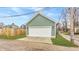 Detached garage with a white door and green siding, offering secure parking and additional storage space at 1224 Keystone Ave, Indianapolis, IN 46201