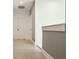Hallway featuring neutral paint, light wood floors, and white doors with black hardware at 1224 Keystone Ave, Indianapolis, IN 46201