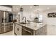Kitchen island with stainless steel dishwasher, granite counter, and stainless steel fridge at 1224 Keystone Ave, Indianapolis, IN 46201