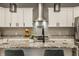 Gourmet kitchen featuring white cabinets, granite countertops, stainless steel appliances, and an island at 1224 Keystone Ave, Indianapolis, IN 46201