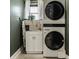 Efficient laundry room with stacked washer/dryer, a utility sink, and ample counter space for folding clothes at 1224 Keystone Ave, Indianapolis, IN 46201
