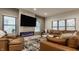 Comfortable living room featuring a modern fireplace, a large TV, and a plush leather sectional sofa at 1224 Keystone Ave, Indianapolis, IN 46201