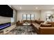Relaxing living room with a modern fireplace, a large TV, and a plush leather sectional sofa at 1224 Keystone Ave, Indianapolis, IN 46201