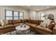 Spacious living room with a large sectional couch and lots of natural light from the windows at 1224 Keystone Ave, Indianapolis, IN 46201