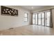 Bright, open living area with hardwood floors, large windows and sliding glass doors at 1224 Keystone Ave, Indianapolis, IN 46201