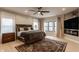 Spacious main bedroom features a ceiling fan, hardwood floors and a modern fireplace at 1224 Keystone Ave, Indianapolis, IN 46201
