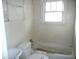 Bathroom with a tub, toilet, and sink at 1300 W 13Th St, Muncie, IN 47302