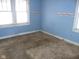 Small bedroom with light blue walls and dirty carpet at 1300 W 13Th St, Muncie, IN 47302