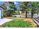 View of backyard with white fencing, concrete pad, and wooden deck at 233 W Westfield Blvd, Indianapolis, IN 46208