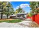Backyard features a multi-level deck, lush lawn, and beautiful landscaping at 233 W Westfield Blvd, Indianapolis, IN 46208