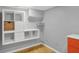 Organized walk-in basement closet with shelving, drawers, and a small chest of drawers at 233 W Westfield Blvd, Indianapolis, IN 46208