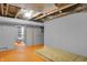 Unfinished basement space with painted concrete walls and flooring with exposed ceiling at 233 W Westfield Blvd, Indianapolis, IN 46208