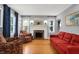 Cozy living room featuring a fireplace, hardwood floors, and abundant natural light at 233 W Westfield Blvd, Indianapolis, IN 46208