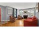 Cozy living room featuring a fireplace, hardwood floors, and abundant natural light at 233 W Westfield Blvd, Indianapolis, IN 46208