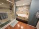 Updated bathroom with a soaking tub, walk-in shower, and stone feature wall at 3163 S 25 E, Shelbyville, IN 46176