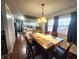 Dining room with hardwood floors, large windows, and kitchen views at 3163 S 25 E, Shelbyville, IN 46176