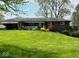 Brick ranch house with a large yard, attached garage, and deck at 3163 S 25 E, Shelbyville, IN 46176