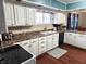 Eat-in kitchen with white cabinets, tile backsplash, and hardwood floors at 3163 S 25 E, Shelbyville, IN 46176