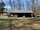 Wooden shed with covered area in the backyard at 3163 S 25 E, Shelbyville, IN 46176