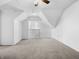 Large attic bedroom with neutral carpeting at 320 W 6Th St, Muncie, IN 47302