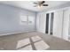 Light blue bedroom with ceiling fan and double door closet at 320 W 6Th St, Muncie, IN 47302