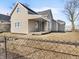 Tan house with a covered porch and fenced yard at 320 W 6Th St, Muncie, IN 47302