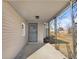 Covered porch with a metal security door at 320 W 6Th St, Muncie, IN 47302
