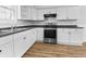 Modern kitchen with white cabinets, dark countertop and stainless steel appliances at 320 W 6Th St, Muncie, IN 47302